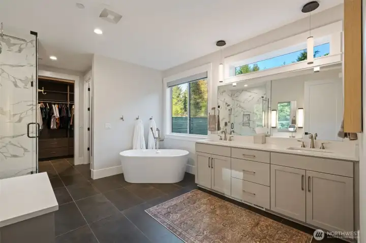 Primary bathroom with free-standing tub, walk in shower, double vanity, walk in closet