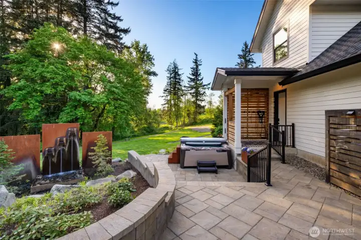 Hot Tub on patio behind ADU, water feature