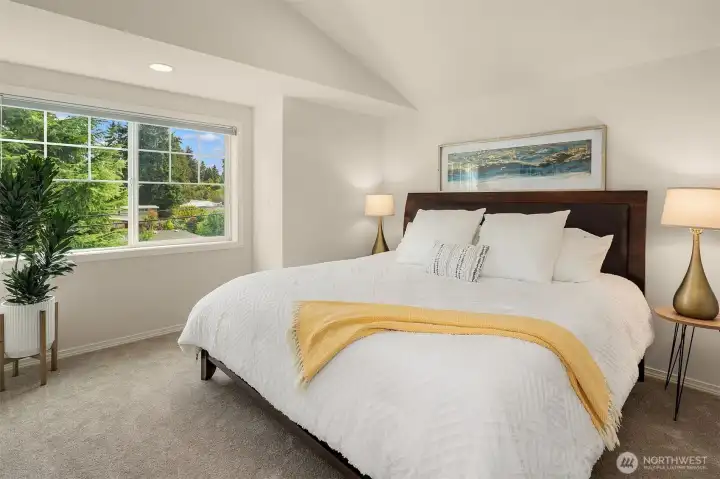 Enjoy views of greenery in the primary bedrooom.