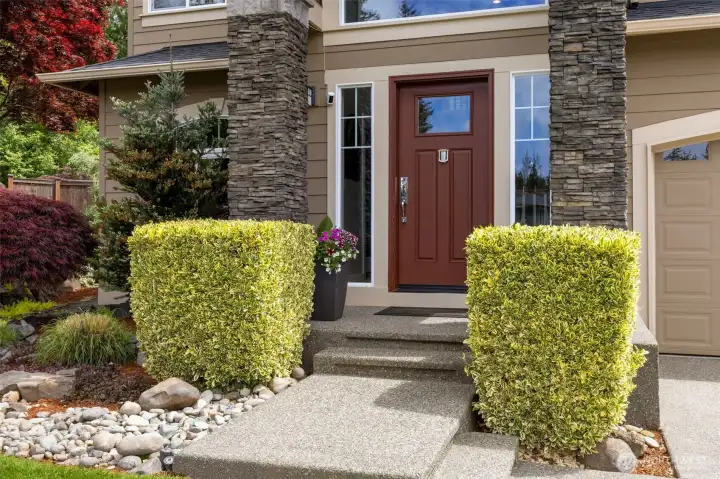 Mature landscaping frames this welcoming entryway.