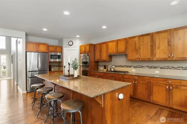Stunning kitchen with granite countertops, stainless appliances, a walk-in pantry, gas cooktop and double ovens.