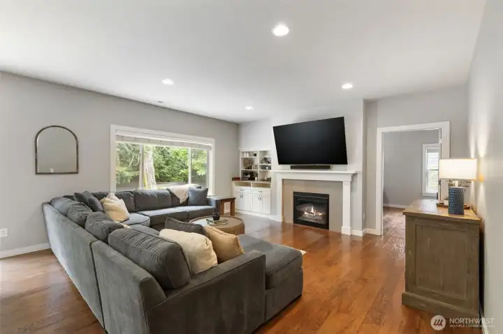 Spacious open concept floorplan with gas fireplace, built-in storage and easy access to the backyard.