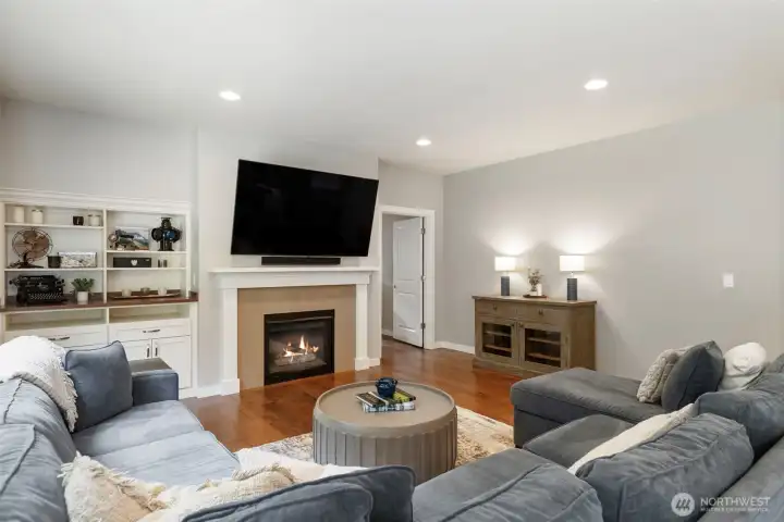 Famiiy room, with FP, custom built-ins and a bonus room just to the side (makes a great playroom, media room or home gym!