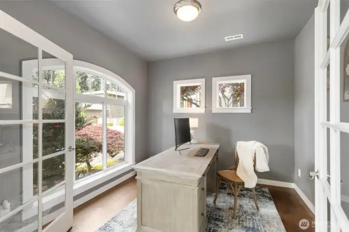 Dedicated office at the front of the home on the main level has French doors and a great view!