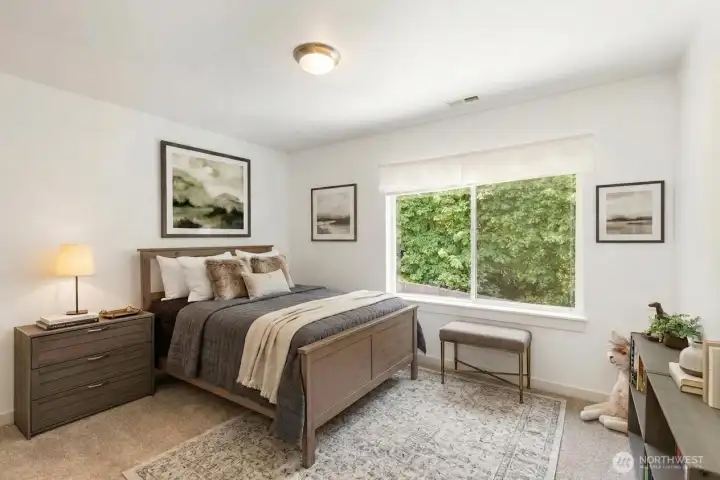 Bedroom 3 of 4 on upper level. Great view of backyard and closet features custom organizing system.