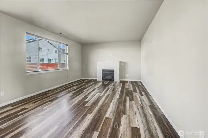 Back living/family room with LVP floors and gas fireplace.