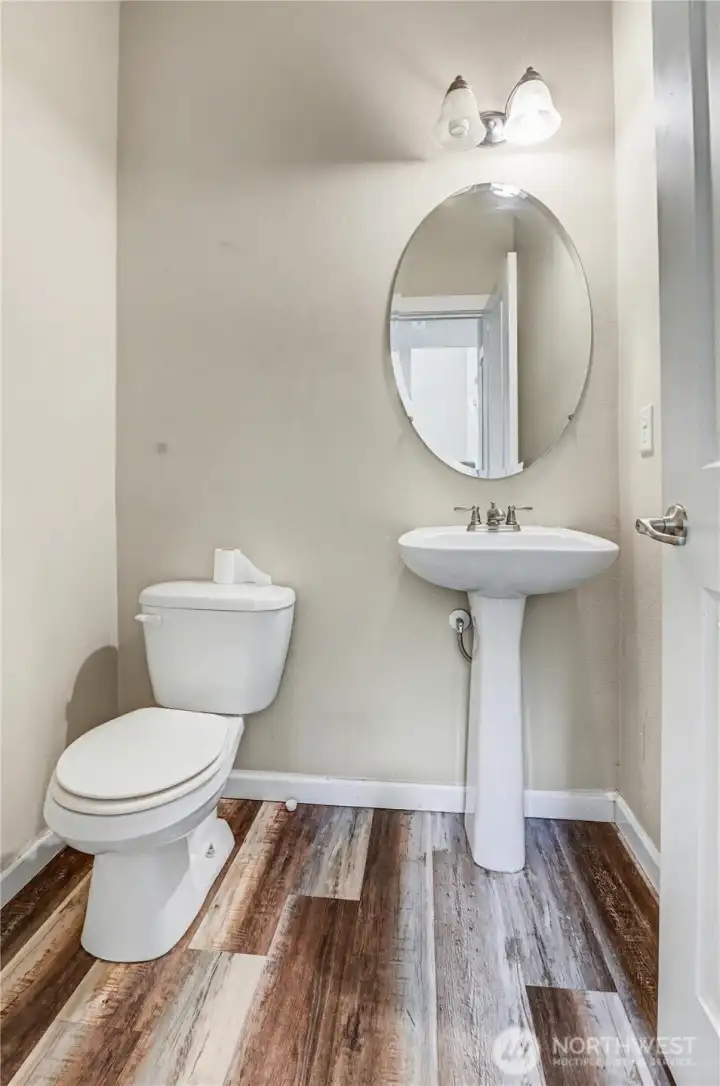 Half bath on main floor with LVP flooring