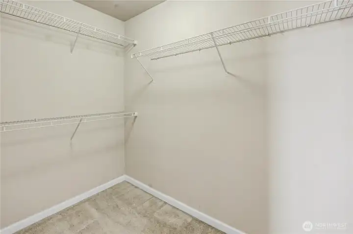 Primary en-suite walk-in closet with wire shelving