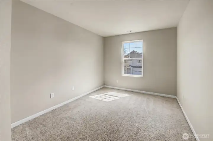 Bedroom with carpeting located on upper level.