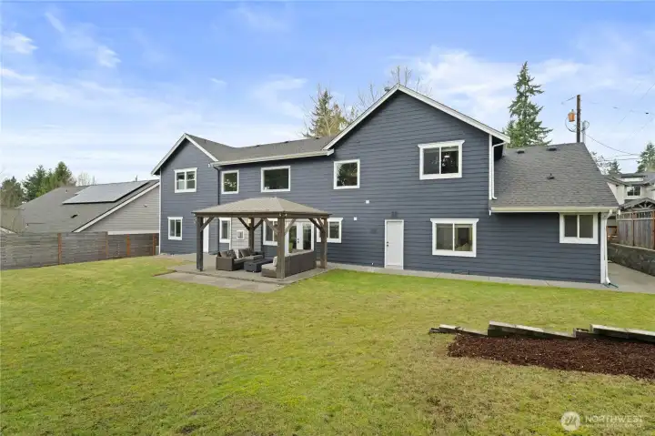 Large level and fully fenced backyard with patio and gazebo. Room for garden and play area.
