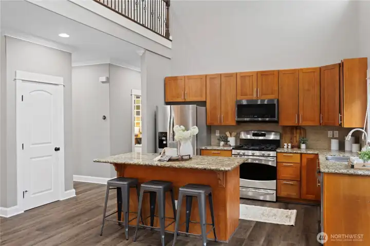 Kitchen with gorgeous cherry-stained cabinets and center island. The door to the left is for the walk-in pantry.