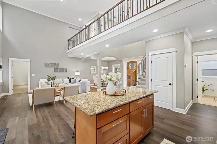 Upstairs, the dramatic catwalk leads to a dedicated office and a generous bonus room.