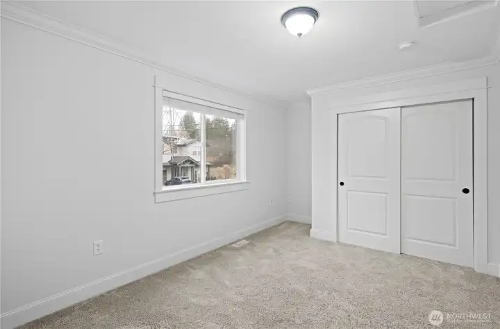 One of two upper-level bedrooms with views to the front of the home.