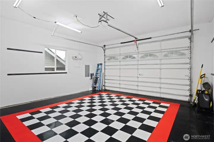 Oversized 2-car garage with interlocking nonslip garage tiles for durability & easy cleaning plus plenty of light.