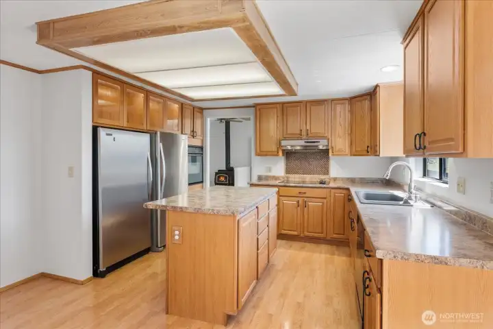 Spacious kitchen with eating room, generous island, full size refrigerator as well as a full size freezer.