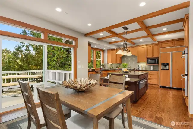 Casual dining area open to the living room and kitchen with a slider to the deck for seamless indoor-outdoor living.