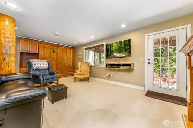 Family/rec room walks out to fire pit area and garden. Also has additional murphy bed for guests!