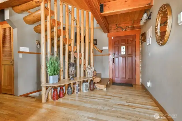 Entry Hall and gorgeous log spiral staircase.