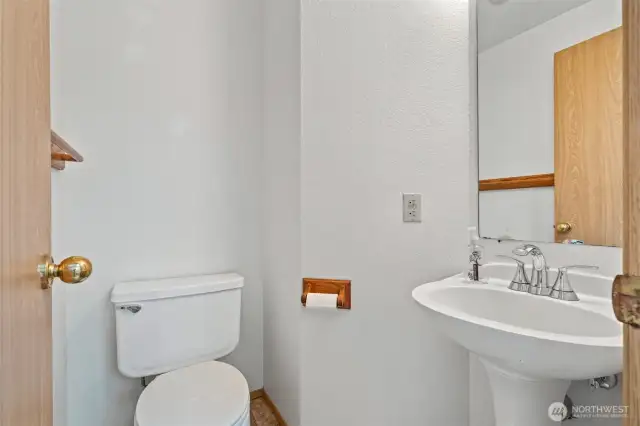 Powder room down stairs in entry way.