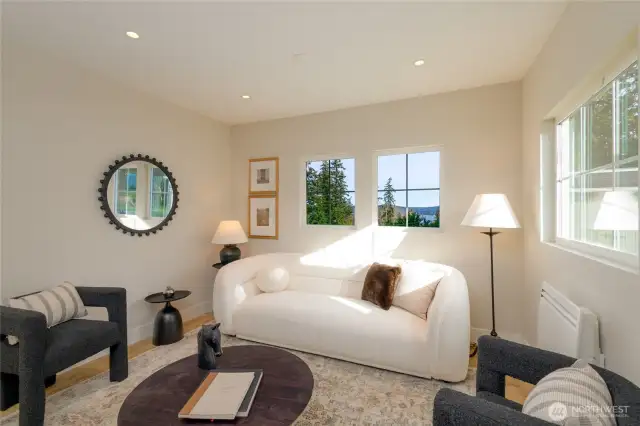 main level entry family seating room with water views