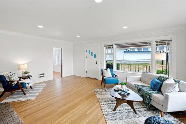 Just inside the front door is the spacious living room with large picture window, hardwood flooring and decorative fireplace to the left.
