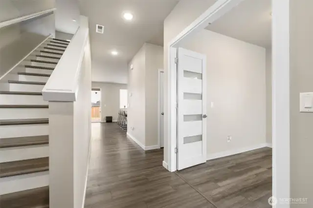 Light-filled entry with instant wow factor — Soaring ceilings, designer flooring, and modern French doors create a grand first impression and lead seamlessly into open-concept living.