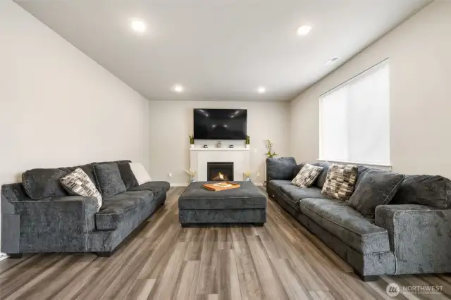 Gather, relax, and make memories — The spacious great room centers around a cozy gas fireplace, offering the perfect blend of warmth, comfort, and modern style for everyday living and entertaining.