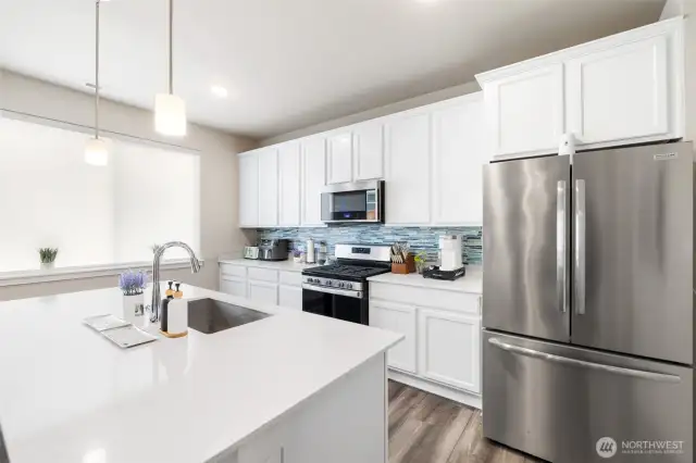 With a spacious island, modern appliances, and stylish finishes, this thoughtfully designed kitchen is ready for everything from weeknight meals to weekend entertaining.