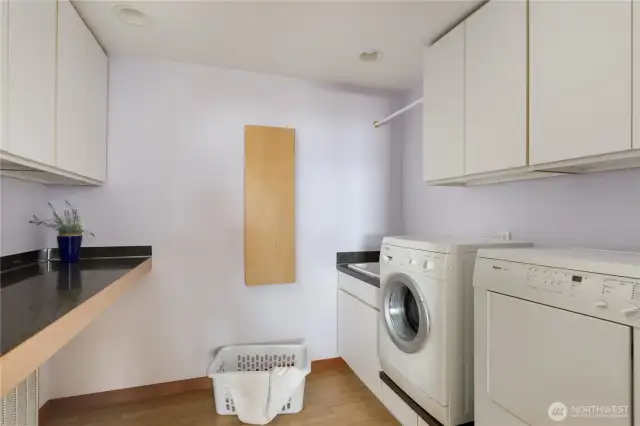 Fantastic utility room with built in folding counter, ironing board, an abundance of cabinets plus a utility sink!!