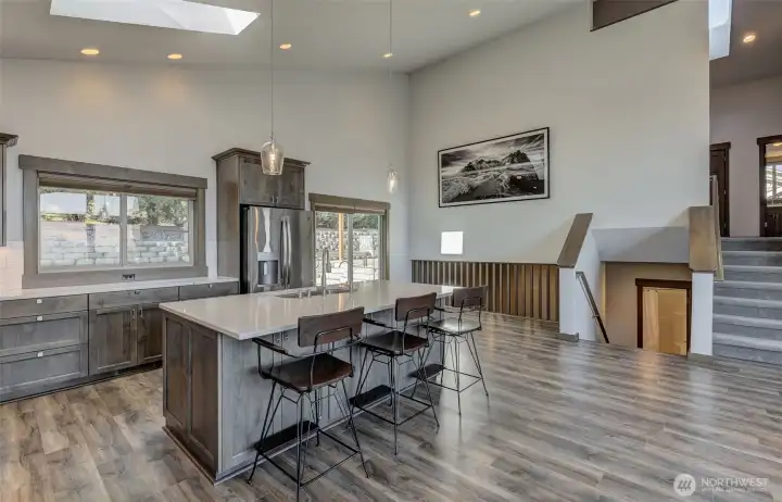 Kitchen open to dining room, slats provide open concept into living room below