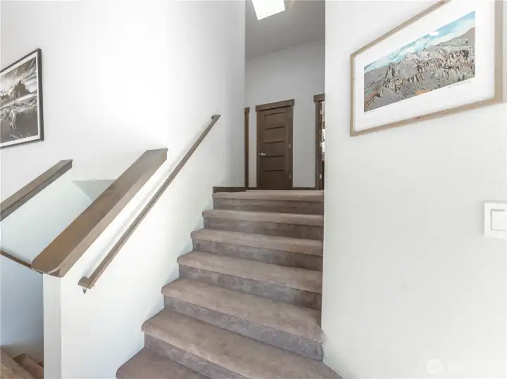 Modern staircase with clean lines connecting all three levels of the home.