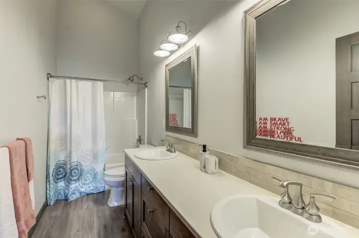 Upper-level full bathroom with modern tile, sleek vanity, and premium finishes.