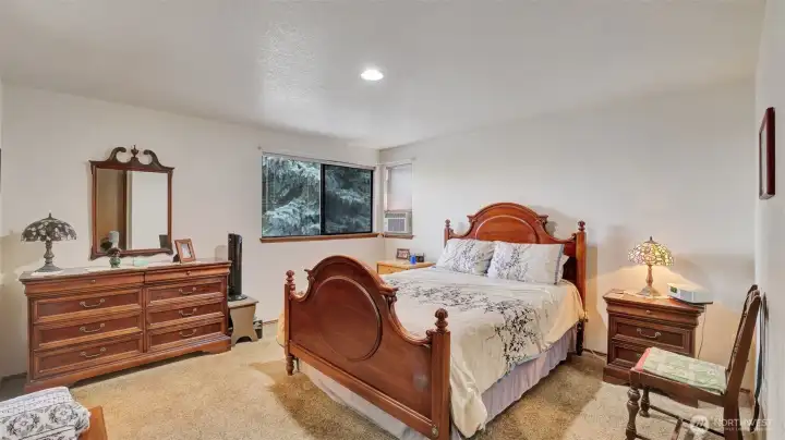 Large primary bedroom with walk-in closet and attached bathroom.