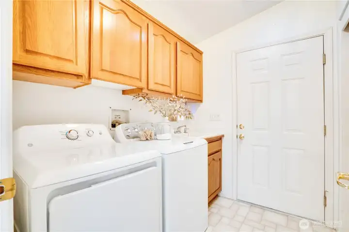 Laundry room with pocket door off of the kitchen. From here you access the garage.