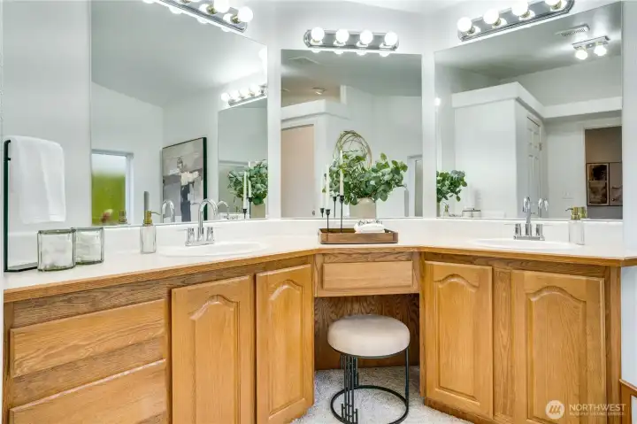 Large double vanity with seating and ample lighting.