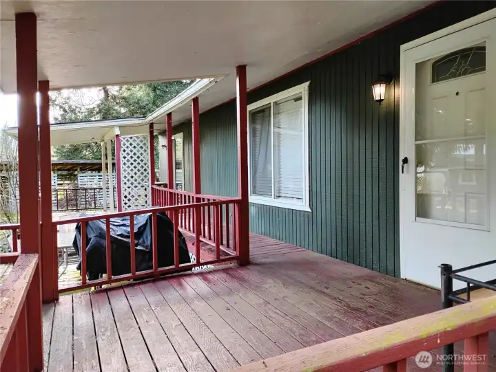 The deck is covered and there is wall mounted lighting on both sides of the house.
