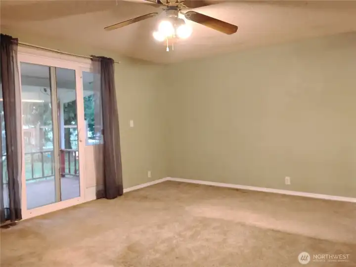 Primary bedroom with walk in closet.  Overhead fan light fixture.