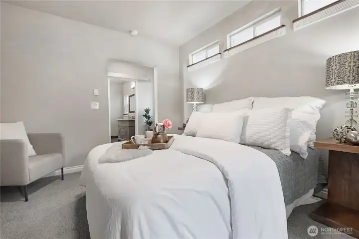 Primary bedroom with views into bathroom