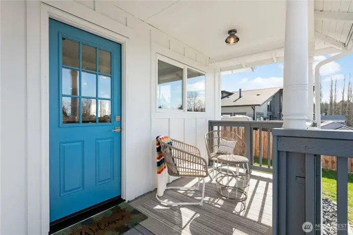 Covered back porch off kitchen with bay and city views
