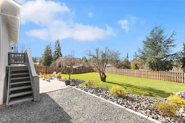 Backyard off driveway, stairs up to pack porch and kitchen