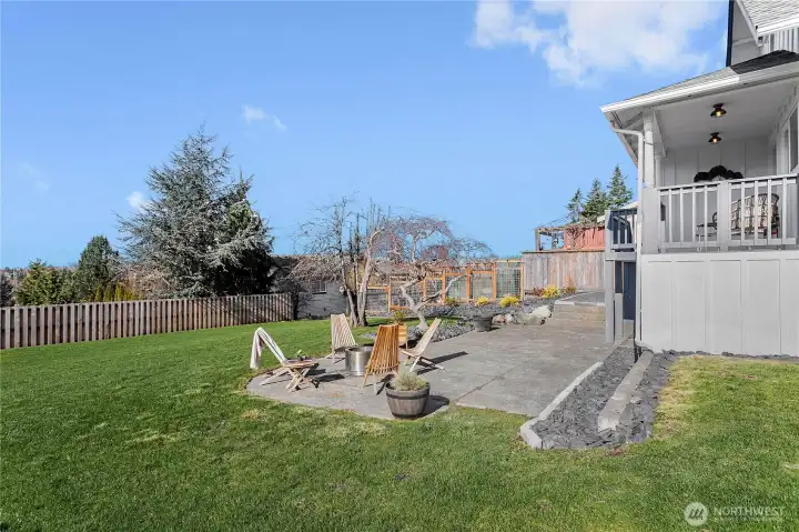 Back patio, partially fenced yard