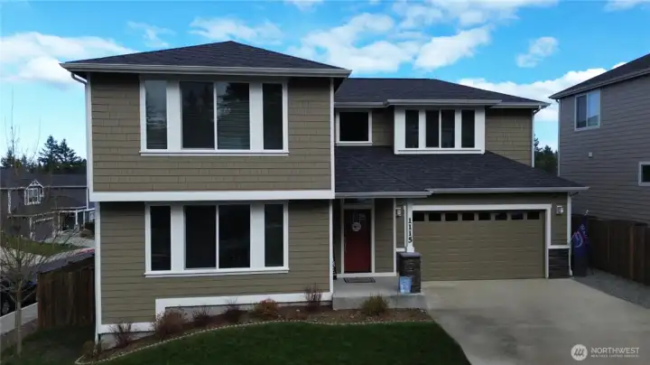 Front of home, which faces the west.  Large driveway can hold 4 cars with a large 2 car garage.