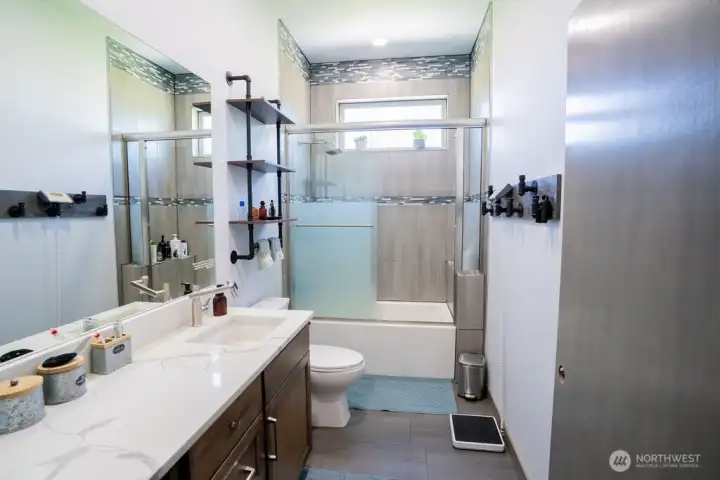 Guest bath with full tile tub and shower combo