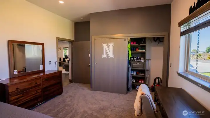 Large closest with solid core doors and built in shelving in guest bed 2