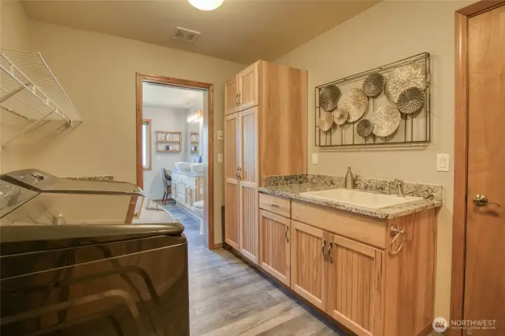 Laundry room is conveniently located adjacent to the primary suite and garage. Washer and dryer are included with purchase of home