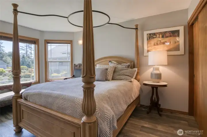 Guest bedroom 1 is located on opposite side of the home away from primary suite. Large windows to take in the beautiful sunrises over the bay