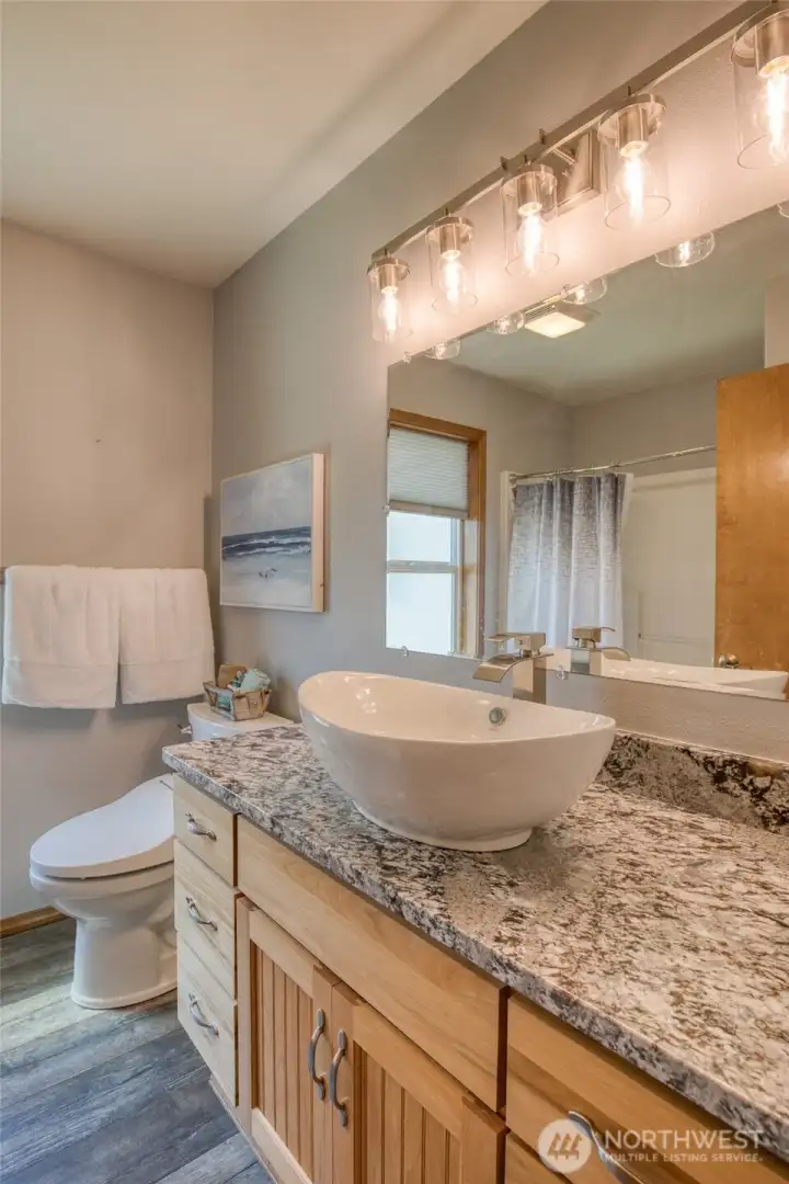 Guest bathroom with matching vessel sinks and granite countertops