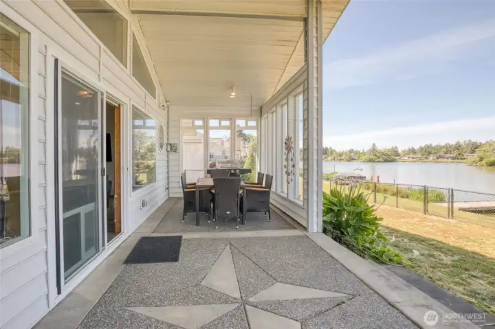 Beautiful concrete patio leads to backyard and lake