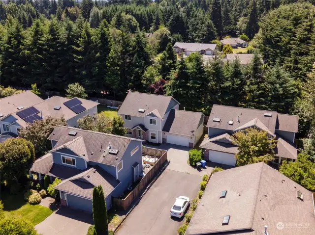 Drone shot of the home which is in the back middle of the picture.  Sets back from Main Street with long driveway.notice the green belt behind the home for privacy.