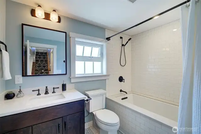 Full main floor bath with deep soaking tub and Carrara marble floor.